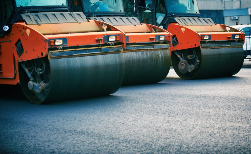 Road roller working on the new road construction site